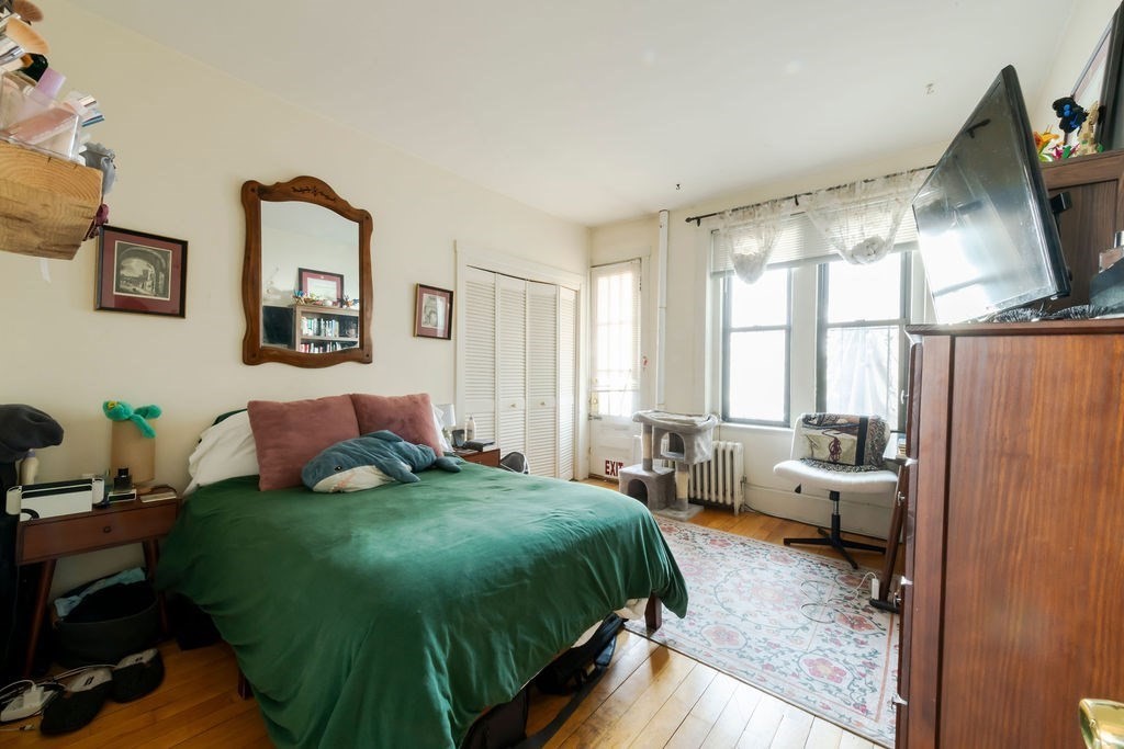 1161 Commonwealth Avenue, Unit 2 Boston, MA 02134 - Photo 9 of 17 a bedroom with a bed and glass window