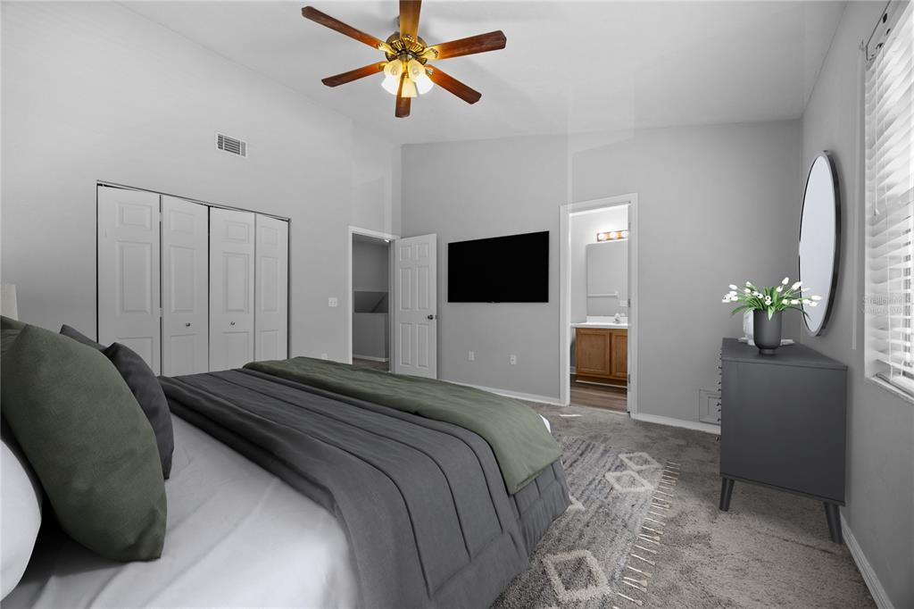 5291 Southwest 97 Way Gainesville, FL 32608 - Photo 15 of 24 a bedroom with a bed and a flat screen tv