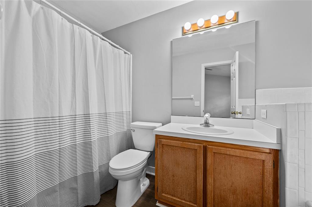 5291 Southwest 97 Way Gainesville, FL 32608 - Photo 16 of 24 a bathroom with a sink a toilet and mirror