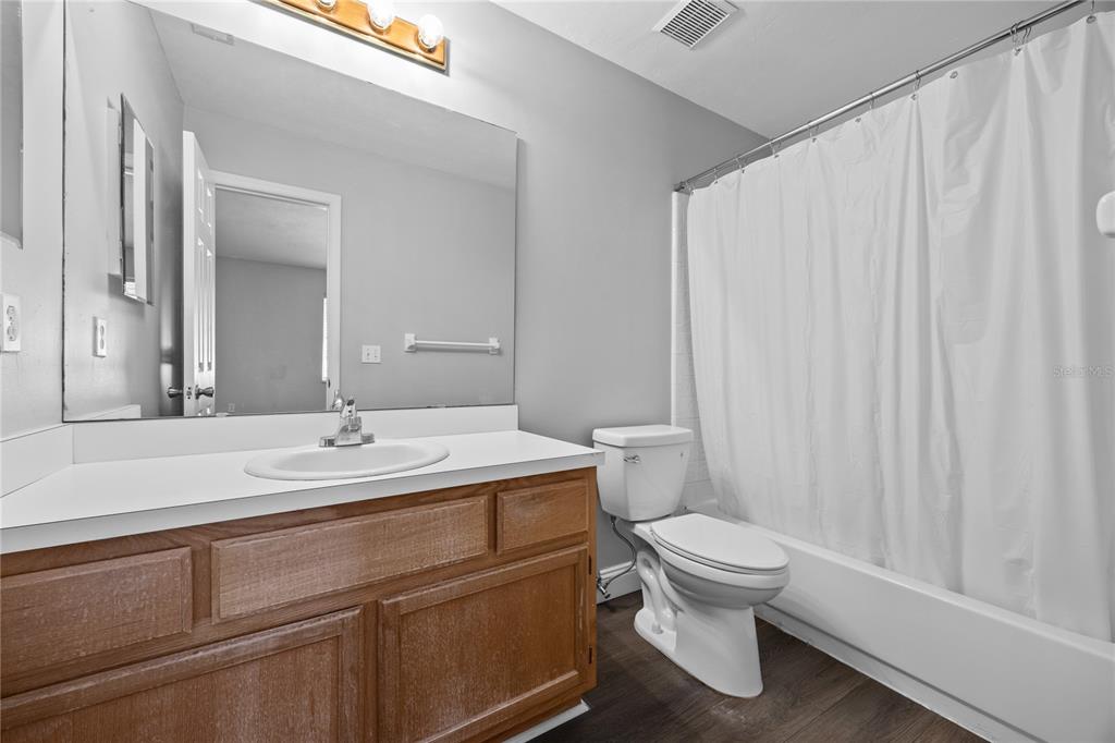5291 Southwest 97 Way Gainesville, FL 32608 - Photo 20 of 24 a bathroom with a sink a toilet and a mirror