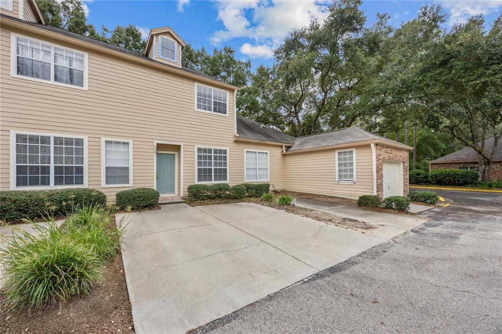 5291 Southwest 97 Way Gainesville, FL 32608 - Photo 2 of 24 a view of backyard of house with outdoor seating and trees