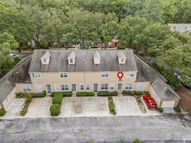 an aerial view of a house with a yard