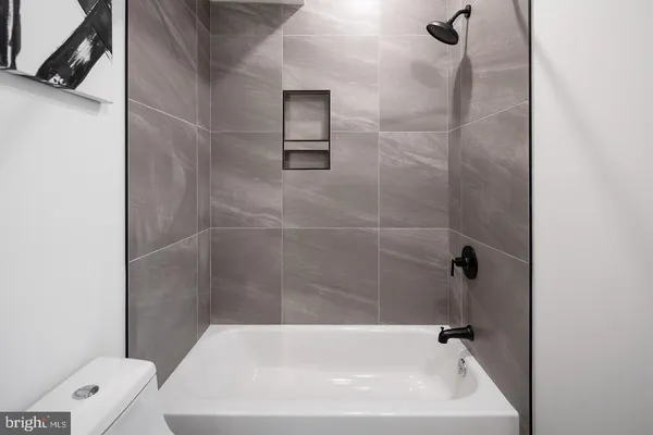 a bath tub sitting next to a white toilet