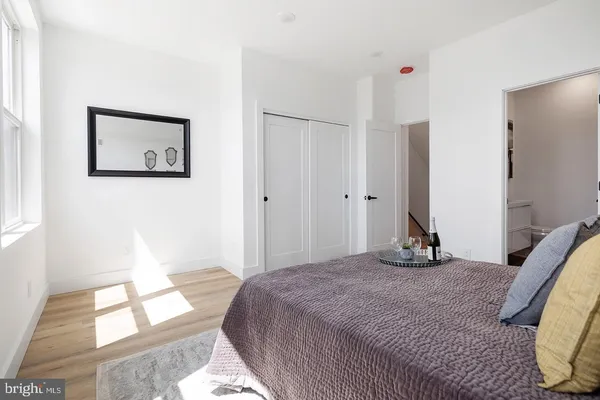 a bedroom with a bed and a window