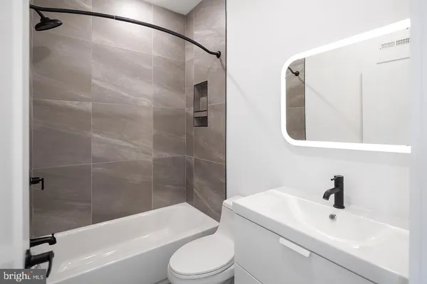 a bathroom with a toilet sink and shower