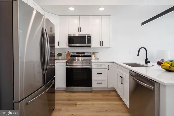 a kitchen with stainless steel appliances a refrigerator stove and sink