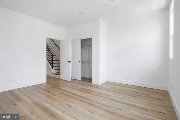an empty room with wooden floor