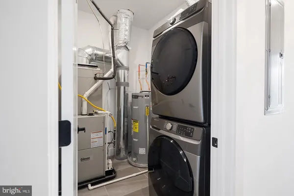 a view of a storage and utility room with a washer dryer