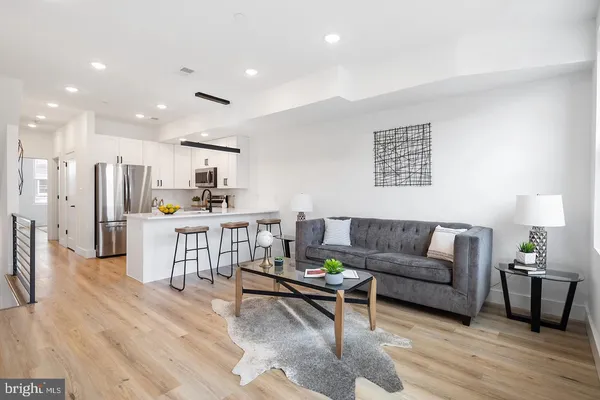 a living room with furniture and kitchen view