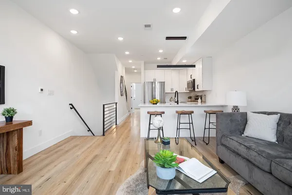 a living room with dining room and wooden floor