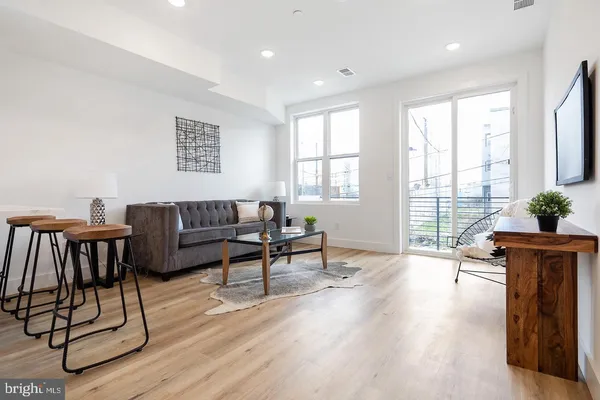 a living room with furniture a table and a potted plant