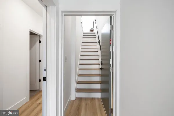 a view of a hallway with stairs and a window