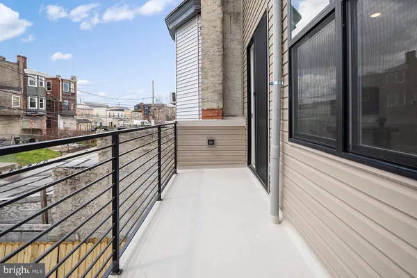 a view of balcony with double vanity and glass door