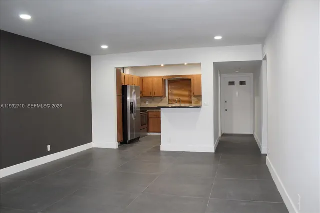 an empty room with a fireplace and a window