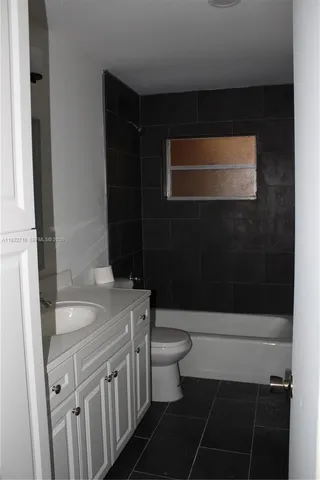 a bathroom with a sink a toilet a shower and a mirror