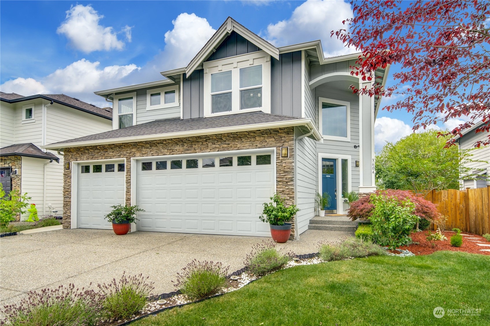 3604 222nd Place Southeast Bothell, WA 98021 - Photo 38 of 38 a front view of a house with a yard and potted plants