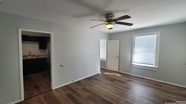 wooden floor in an empty room with a window