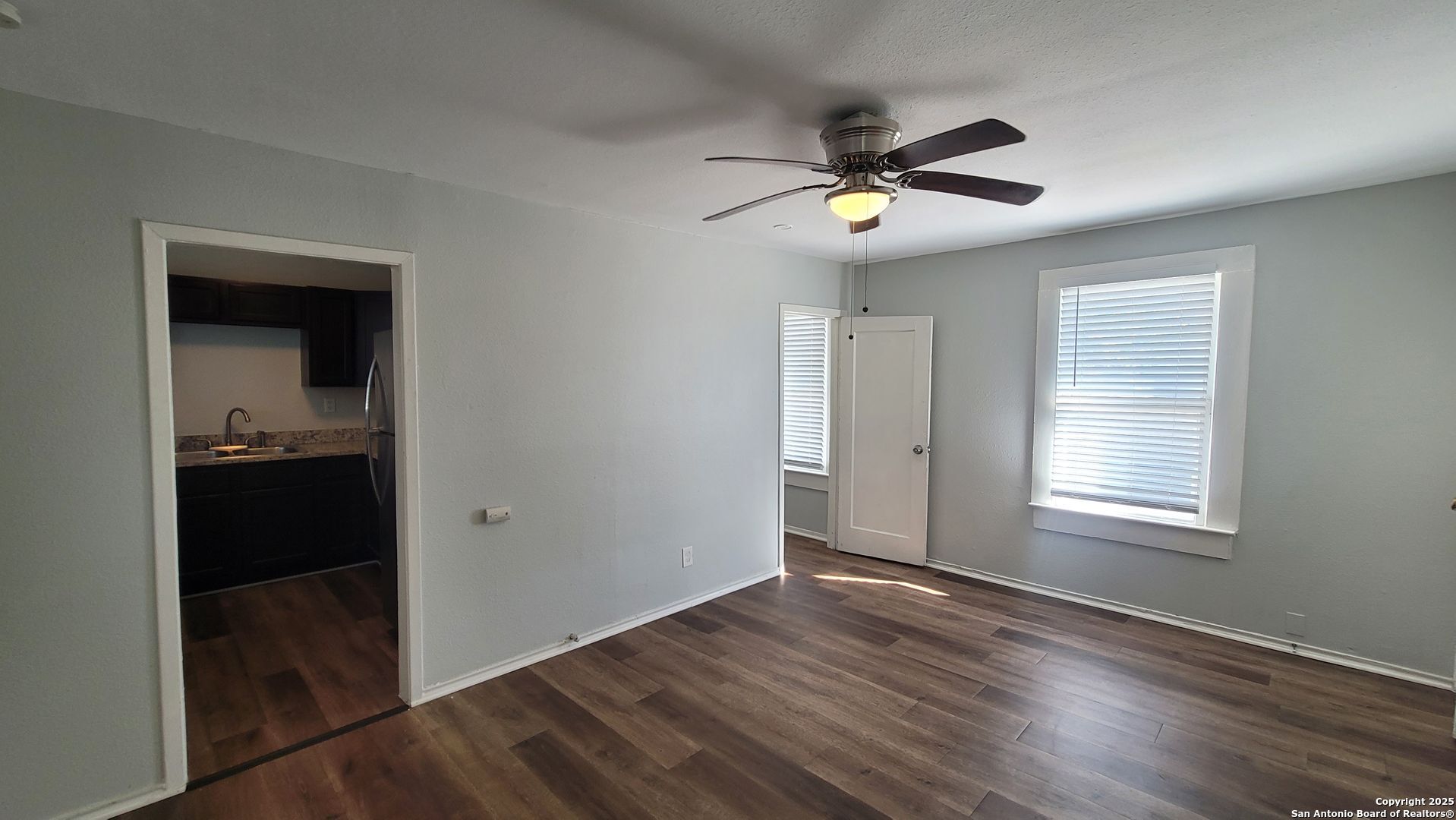3101 North Elmendorf Street, Unit 2 San Antonio, TX 78201 - Photo 3 of 11 wooden floor in an empty room with a window