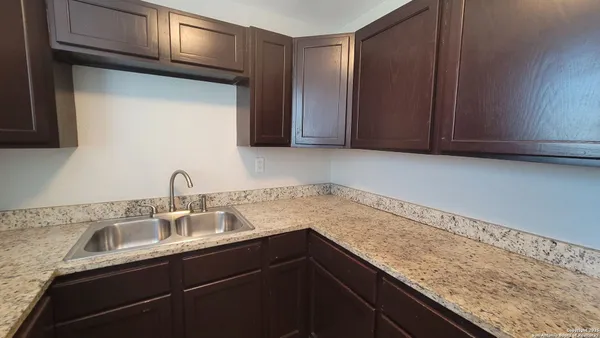 a kitchen with a sink and cabinets
