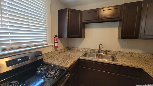 a kitchen with a sink stove and microwave