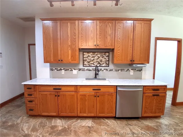 a view of a kitchen with wooden cabinets