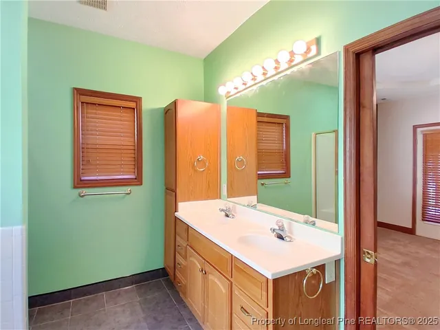 a bathroom with a sink a mirror and a