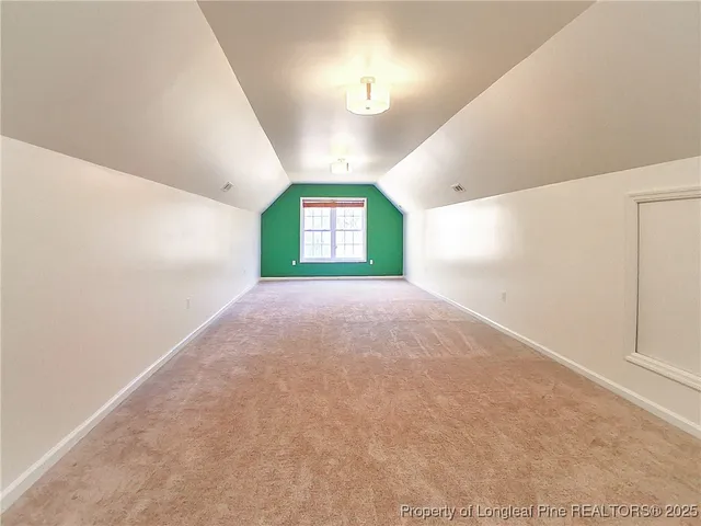 a view of a big room with windows and fireplace