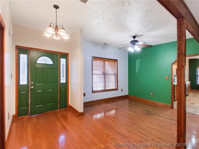 a view of a room with window ceiling fan and bathroom