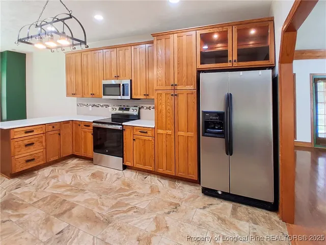 a kitchen with stainless steel appliances granite countertop a refrigerator and a sink