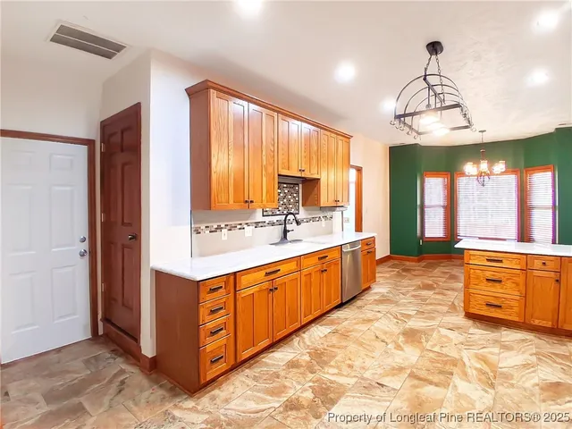 a large kitchen with kitchen island granite countertop a large counter top and sink