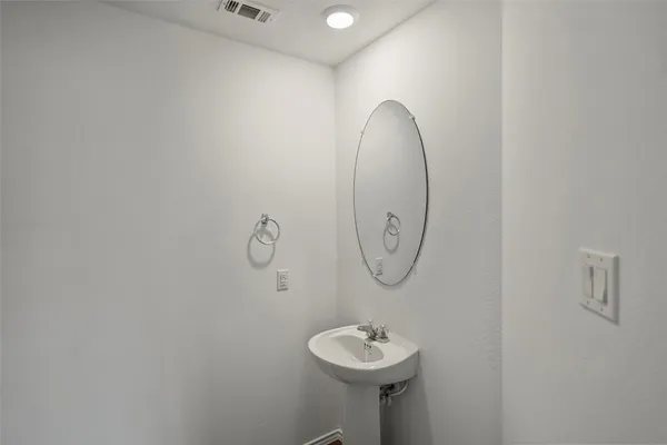 a bathroom with a sink mirror and toilet