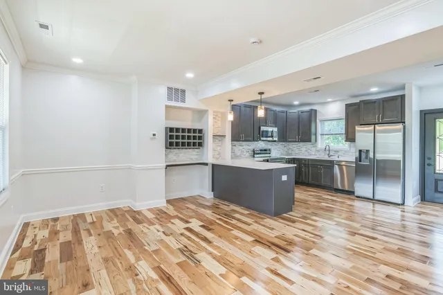 a kitchen with a refrigerator and a sink