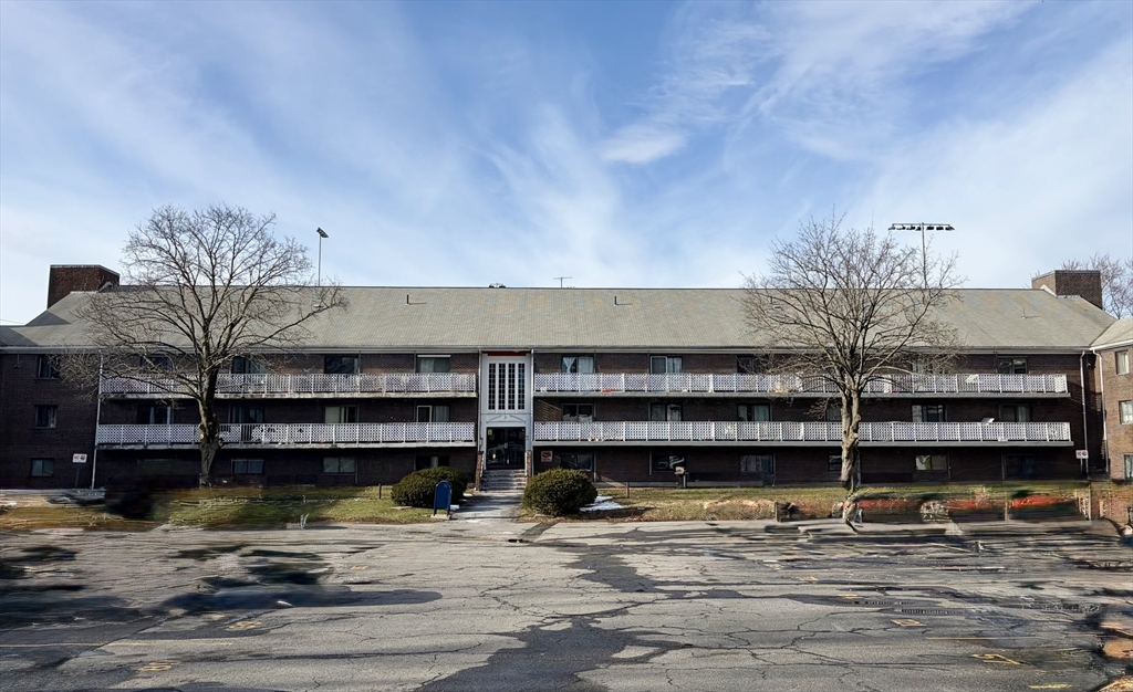 a view of a building with a window and potted plants