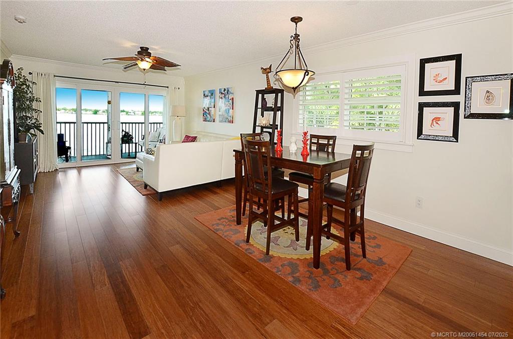 1860 Southwest Palm City Road, Unit 206 Stuart, FL 34994 - Photo 12 of 39 a view of a dining room with furniture window and wooden floor