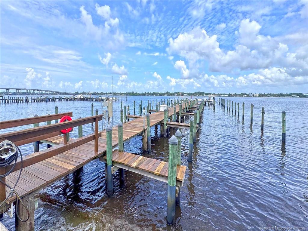 1860 Southwest Palm City Road, Unit 206 Stuart, FL 34994 - Photo 8 of 39 a roof deck with table and chairs a barbeque