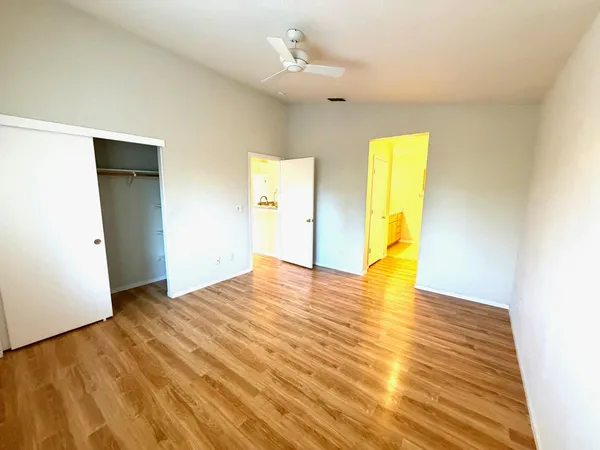 a view of empty room with wooden floor
