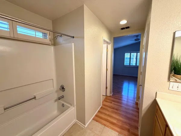a bathroom with a bathtub and a shower