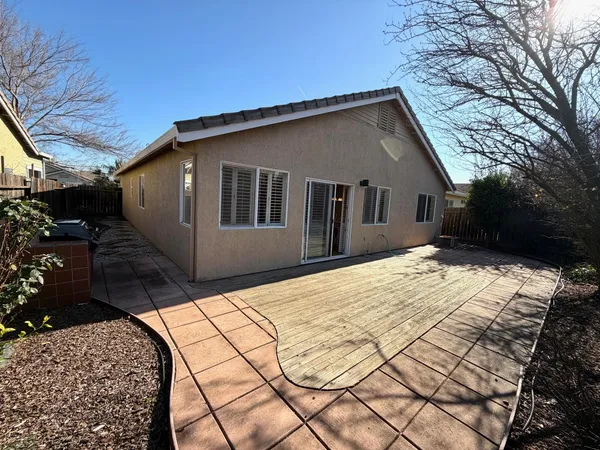 a backyard of a house with wooden fence