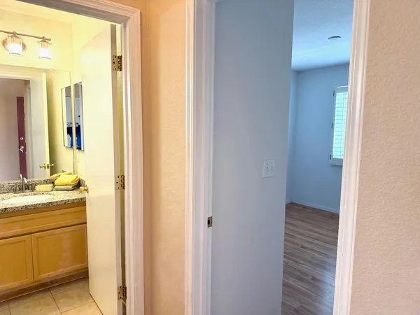 a bathroom with a granite countertop sink and a mirror