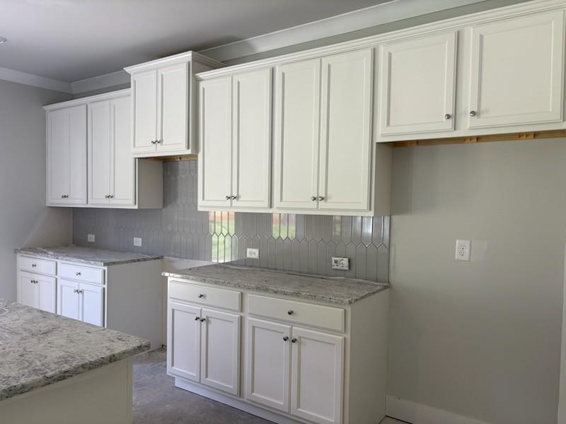 6 Commons Way Cartersville, GA 30120 - Photo 5 of 37 a kitchen with granite countertop white cabinets and sink