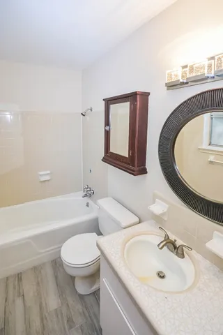 a bathroom with a toilet a sink and bathtub