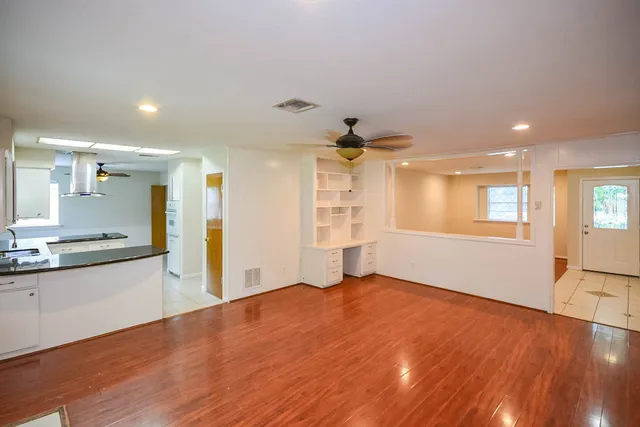 a view of a kitchen with wooden floor and a kitchen