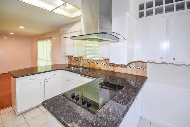 a kitchen with stainless steel appliances granite countertop a sink and a stove