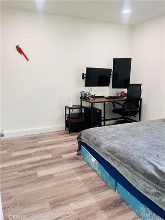 a bedroom with furniture and flat screen tv