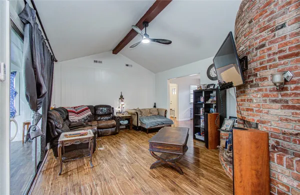 a living room with furniture and wooden floor