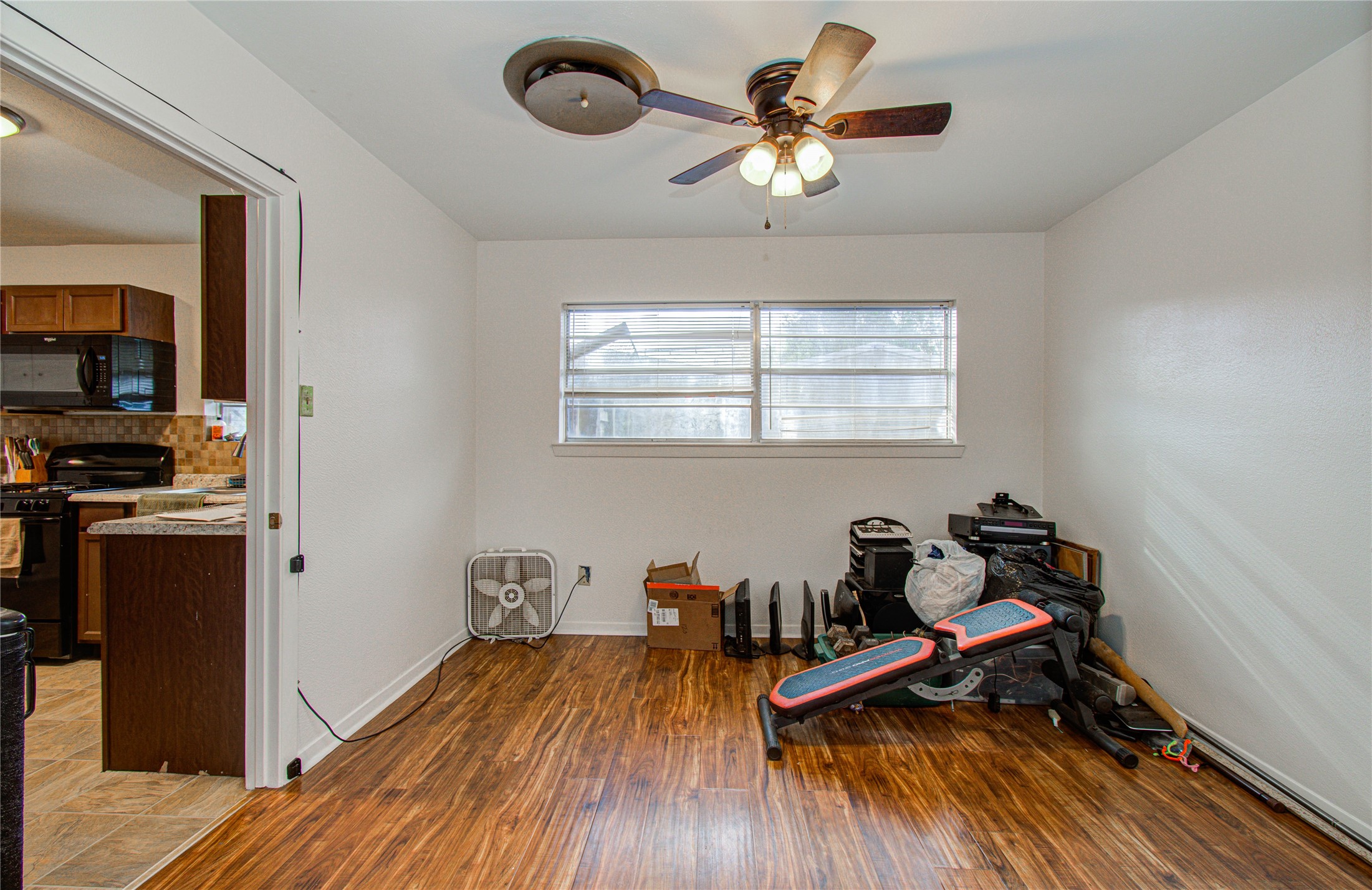 1710 West 11th Street Freeport, TX 77541 - Photo 12 of 34 a dining room with wooden floor and a window