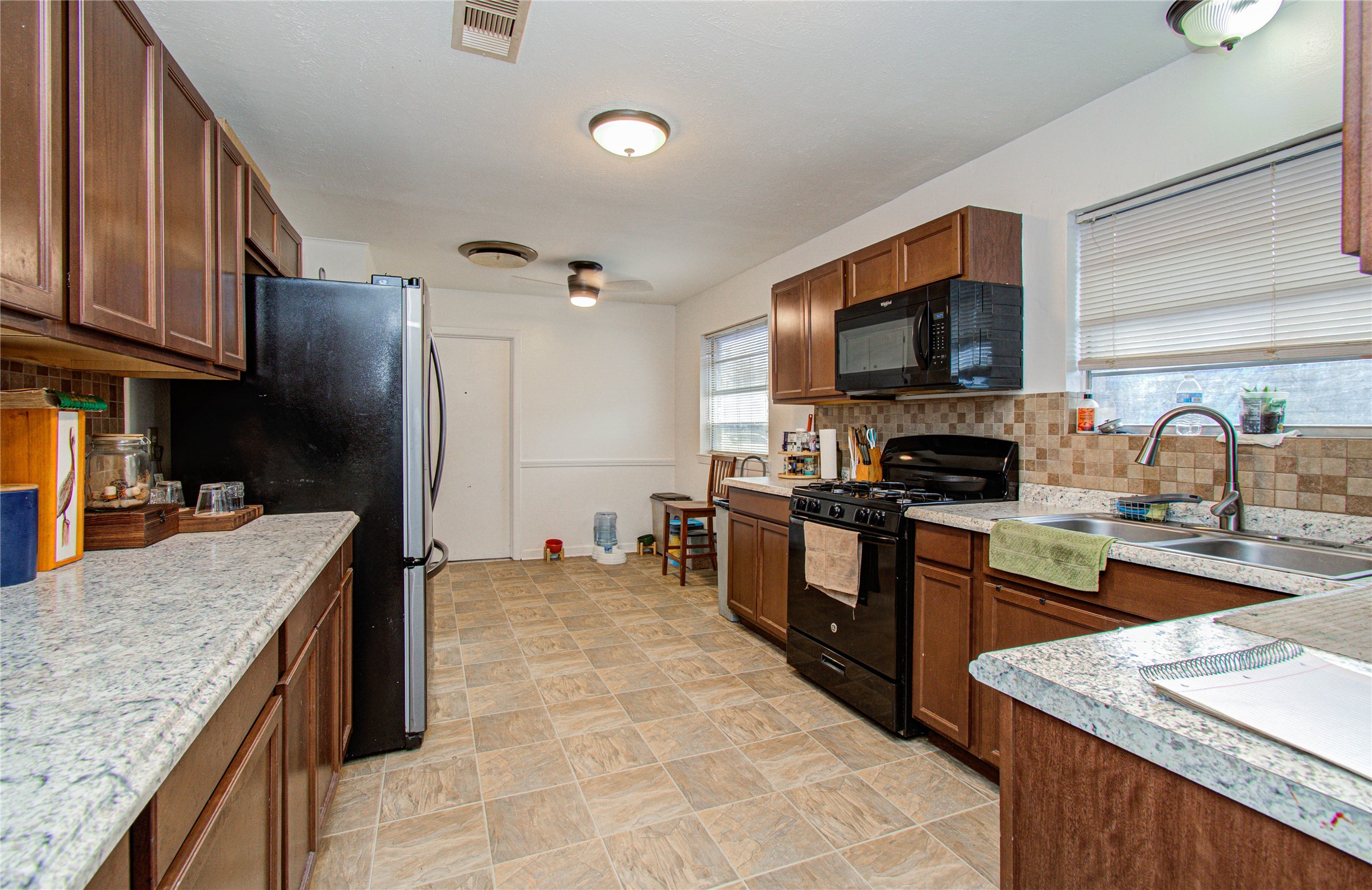 1710 West 11th Street Freeport, TX 77541 - Photo 14 of 34 a kitchen with stainless steel appliances granite countertop a sink stove and refrigerator