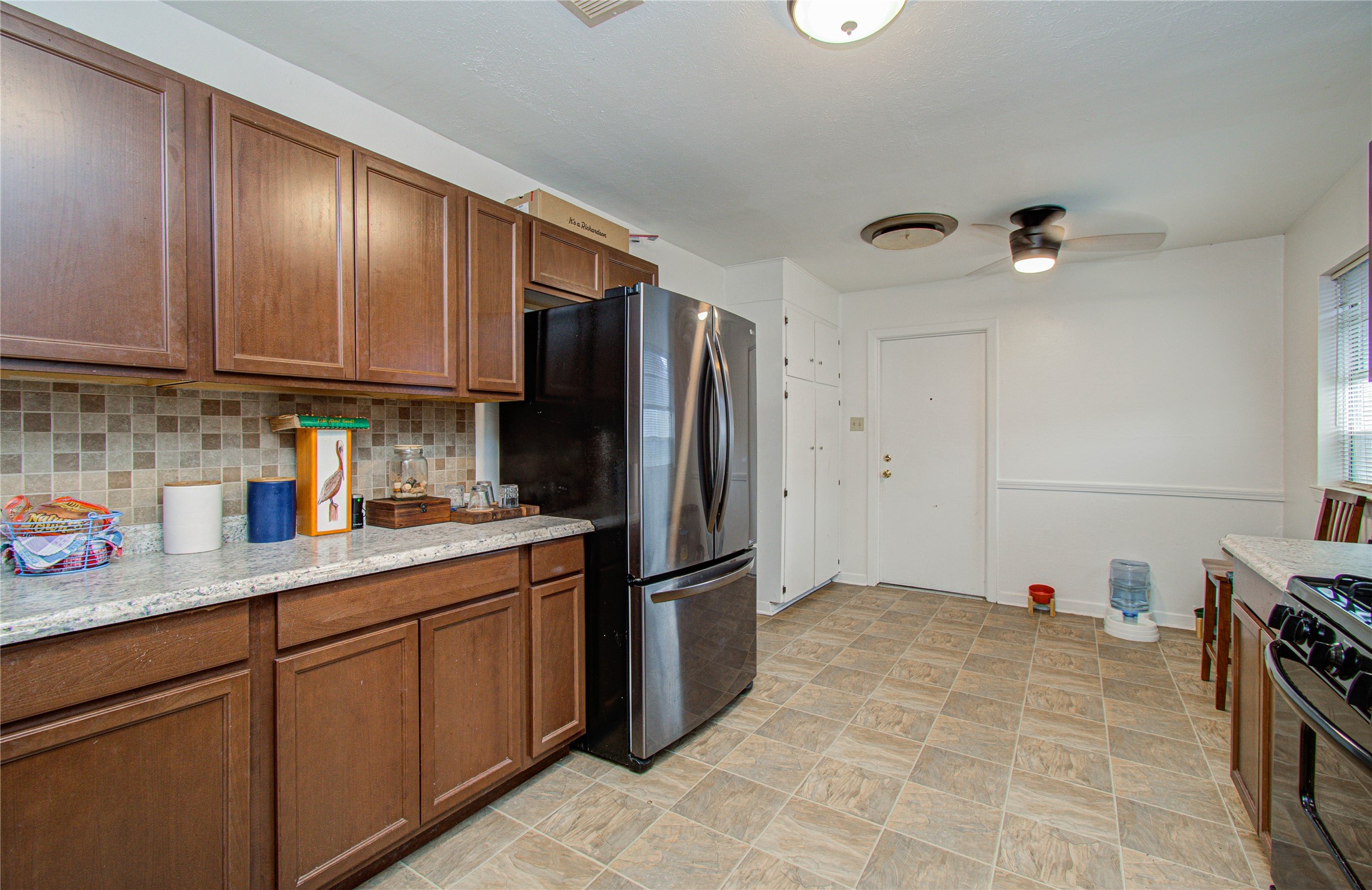 1710 West 11th Street Freeport, TX 77541 - Photo 16 of 34 a kitchen with stainless steel appliances granite countertop a refrigerator stove and sink