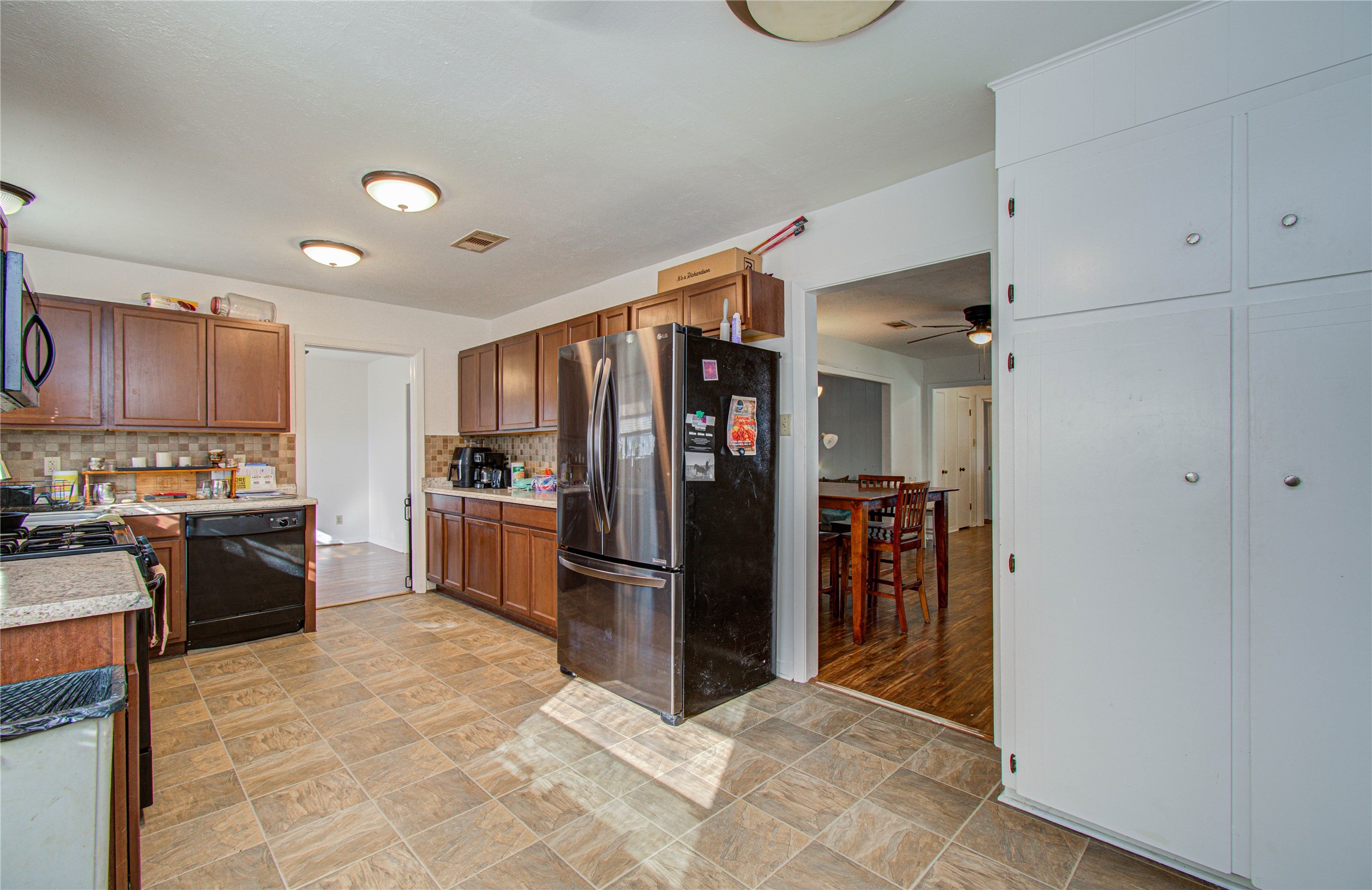 1710 West 11th Street Freeport, TX 77541 - Photo 18 of 34 a kitchen with refrigerator and cabinets