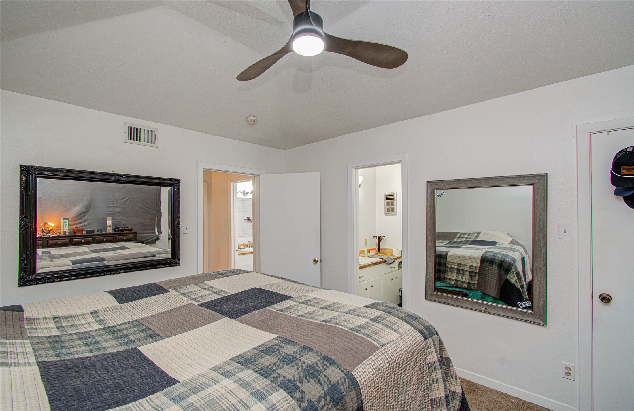 1710 West 11th Street Freeport, TX 77541 - Photo 21 of 34 a bedroom with a bed and a painting on the wall